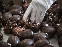 An employee of pastry and chocolate maker Didier Girard prepares Easter chocolate before delivering them at clients' homes in Vourles, near Lyon at on April 7, 2020, on the twenty-second day of a strict lockdown in France to stop the spread of COVID-19, caused by the novel coronavirus. JEAN-PHILIPPE KSIAZEK / AFP