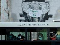Commuters wear face masks aboard a bus in Havana, on April 11, 2020. Cuba hit out at the United States on Friday over its nearly 60-year-old embargo against the island nation, which Havana described as "even more cruel" given the suffering caused by the new coronavirus pandemic. The communist-run single-party island is finding it tough to source medical supplies and has already recorded 620 coronavirus cases and 16 deaths. YAMIL LAGE / AFP