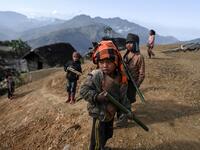 This photo taken on February 9, 2020 shows children playing in Karmawlawyi village in Myanmar's Sagaing region, near the border with India. The king of the Konyak tribe sleeps in Myanmar, but eats in India -- his house, village and people divided by a mountain border which serves as a vulnerable lifeline now severed by a coronavirus lockdown.  Ye Aung THU / AFP