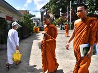 Novice monks wearing masks as a preventive measure against the spread of the COVID-19 coronavirus walk around after religious studies at Wat Molilokkayaram Buddhist temple in Bangkok on April 20, 2020. Lillian SUWANRUMPHA / AFP