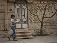 A Syrian boy carries bread back to his home in the city of Qamishli in Syria's northeastern Hasakeh province on April 24, 2020, on the first day of the Muslim holy fasting month of Ramadan despite the COVID-19 coronavirus pandemic. DELIL SOULEIMAN / AFP