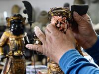 In this picture taken on March 17, 2020, sculptor Lin Hsin-lai restoring a Taoist god statue at his workplace in Taoyuan, northern Taiwan on March 17, 2020.Sam Yeh / AFP