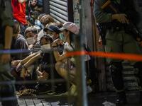Police detain a group of people during a pro-democracy protest calling for the city's independence in Hong Kong on May 10, 2020. ISAAC LAWRENCE / AFP