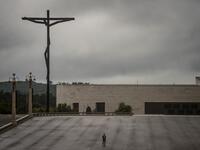 A lone man stands at the Fatima sanctuary during the 103rd anniversary of the apparitions of Our Lady Fatima in central Portugal on May 13, 2020. Without the crowd of pilgrims it welcomes every year, the shrine of Fatima celebrated the anniversary during a religious ceremony reduced to the bare minimum. PATRICIA DE MELO MOREIRA / AFP