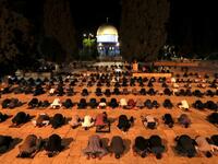 Palestinians perform the dawn prayer (salat al-fajr) inside the al-Aqsa mosque compound, in Jerusalem's Old City on May 31, 2020, after a two-month closure due to the COVID-19 pandemic. AHMAD GHARABLI / AFP