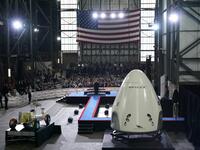 US President Donald Trump speaks near a SpaceX Crew Dragon capsule at a press briefing after the launch of the SpaceX Falcon 9 rocket and Crew Dragon spacecraft on NASA's SpaceX Demo-2 mission to the International Space Station from NASA's Kennedy Space Center in Cape Canaveral, Florida on May 30, 2020. Trump travels to Kennedy Space Center in Florida to watch the launch of the MANDEL NGAN / AFP