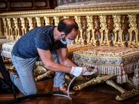 A worker cleans the Queen bedroom (Chambre de la Reine) at the Chateau de Versailles (Palace of Versailles) in Versailles near Paris, on June 5, 2020 on the eve of it re-opening after 82 days of closure due to the novel coronavirus (COVID-19) outbreak. The Palace of Versailles -- France's big tourist attraction with nearly 10 million tourists a year - will open on June 6 with no US or Asia tourists who represent 30% of its visitors. STEPHANE DE SAKUTIN / AFP