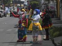 A group of clowns beg for money to survive the crisis caused by the new coronavirus in Villa Nueva, 20 km south Guatemala City, on June 10, 2020, as clowns have been unable to work due to restrictions to prevent the spread of the COVID-19.    Johan ORDONEZ / AFP