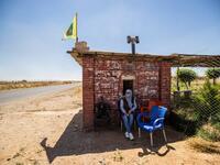 A Kurdish female volunteer, from the newly formed Community Protection Forces, guards a wheat field, against threats by jihadists to burn the crops, during harvest season on June 13, 2020, in the countryside east of Qamishli in Syria's northeastern Hasakah province. Delil SOULEIMAN / AFP