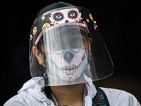 A municipal worker wears a face mask and shield at the Bosa neighborhood, one of the areas with more COVID-19 cases in Bogota, on June 17, 2020. Bogota is on alert for the high occupation of intensive care units amid the new coronavirus pandemic. Juan BARRETO / AFP