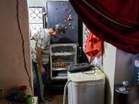 A Lebanese man looks at his empty refrigerator at his apartment in the capital Beirut on June 17, 2020. Lebanon's economic crisis has led to a collapse of the local currency and purchasing power, plunging whole segments of the population into poverty as exemplified by near-empty fridges in many households. ANWAR AMRO / AFP