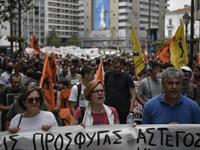 Solidarity groups and NGO's march behind banners as they participate in a rally in Athens on June 20, 2020, marking World Refugee Day as they demand rights and housing for refugees and migrants in Greece. Louisa GOULIAMAKI / AFP