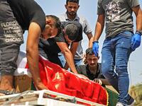 Mourners transport the coffin of slain Iraqi jihadism expert Hisham al-Hashemi, who was shot dead yesterday outside his house in the Iraqi capital, during his funeral in Baghdad’s Zayouna district on July 7, 2020. Hashemi was an authoritative voice on Sunni jihadist factions including the Islamic State group, but was also frequently consulted by media and foreign governments on domestic Iraqi politics and Shiite armed groups. 