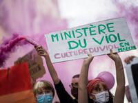 A protester holds a sign reading "Ministry of rape" as another lights a pink flare during a demonstration called by feminist movements in Nantes, western France, on July 10, 2020, to denounce the nomination of French Interior Minister, facing rape accusations and French Justice Minister who criticised the #MeToo movement against sexual harassment. LOIC VENANCE / AFP