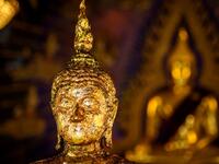 This photograph taken on July 14, 2020 shows Buddha statues inside the Wat Pariwat Buddhist temple in Bangkok. Wat Pariwat, also known as "the David Beckham Temple", is decorated with statues of superheroes and comic characters as well as mythical and imaginary creatures. A golden-plated sculpture of the English football player holding the base of a Buddha statue in one of the buildings gives the temple its nickname. Mladen ANTONOV / AFP
