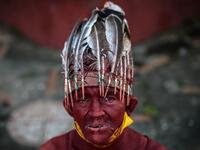 A Catholic faithful painted in red ink poses for a picture as he takes part in the opening of the ten-day celebration of the Santo Domingo de Guzman festival, outside the Las Sierritas de Santo Domingo church in Managua, on August 1, 2020 amid the COVID-19 novel coronavirus pandemic. Despite the Catholic Church cancelling all religious activities due to the coronavirus pandemic, devotees gathered outside the church for the celebration. Inti OCON / AFP