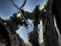 A Catholic faithful smeared in burnt oil and wearing a cross takes part in the opening of the ten-day celebration of the Santo Domingo de Guzman festival, outside the Las Sierritas de Santo Domingo church in Managua, on August 1, 2020 amid the COVID-19 novel coronavirus pandemic. Despite the Catholic Church cancelling all religious activities due to the coronavirus pandemic, devotees gathered outside the church for the celebration. Inti OCON / AFP