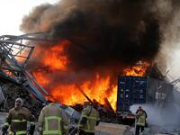 Lebanese firefights extinguish fire at the scene of an explosion at the port in the capital Beirut on August 4, 2020. Two huge explosion rocked the Lebanese capital Beirut, wounding dozens of people, shaking buildings and sending huge plumes of smoke billowing into the sky. Lebanese media carried images of people trapped under rubble, some bloodied, after the massive explosions, the cause of which was not immediately known.  STR / AFP