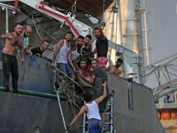 A man is evacuated from a boat following of an explosion near the port in the Lebanese capital Beirut on August 4, 2020. Two huge explosion rocked the Lebanese capital Beirut, wounding dozens of people, shaking buildings and sending huge plumes of smoke billowing into the sky. Lebanese media carried images of people trapped under rubble, some bloodied, after the massive explosions, the cause of which was not immediately known.  STR / AFP
