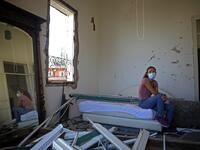 Lebanese dietitian Lama Mattar sits in her damaged bedroom in the damaged neighbourhood of Mar Mikhael in the Lebanese capital Beirut on August 6, 2020, two days after a massive explosion shook the Lebanese capital. The blast, which appeared to have been caused by a fire igniting 2,750 tonnes of ammonium nitrate left unsecured in a warehouse, was felt as far away as Cyprus, some 150 miles (240 kilometres) to the northwest. The scale of the destruction was such that the Lebanese capital resembled the scene o