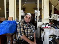 A man sits inside his damaged house in the Lebanese capital Beirut on August 6, 2020, two days after a massive explosion shook the Lebanese capital. The blast, which appeared to have been caused by a fire igniting 2,750 tonnes of ammonium nitrate left unsecured in a warehouse, was felt as far away as Cyprus, some 150 miles (240 kilometres) to the northwest. The scale of the destruction was such that the Lebanese capital resembled the scene of an earthquake, with thousands of people left homeless and thousan