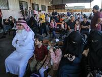 Palestinians wait to cross to the Egyptian side of Rafah border crossing after months of closure due to the coronavirus pandemic in the southern Gaza Strip, on August 11, 2020. SAID KHATIB / AFP