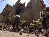 Yemeni labourers remove the rubble ahead of restoration works on the site of a collapsed UNESCO-listed building following heavy rains, in the old city of the Yemeni capital Sanaa, on August 12, 2020. Flash floods triggered by torrential rains have killed at least 172 people across Yemen over the past month, damaging homes and UNESCO-listed world heritage sites, officials said. Mohammed HUWAIS / AFP
