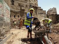 Yemeni labourers remove the rubble ahead of restoration works on the site of a collapsed UNESCO-listed building following heavy rains, in the old city of the Yemeni capital Sanaa, on August 12, 2020. Flash floods triggered by torrential rains have killed at least 172 people across Yemen over the past month, damaging homes and UNESCO-listed world heritage sites, officials said. Mohammed HUWAIS / AFP