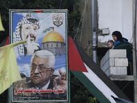 A woman carrying a child looks out her balcony during a demonstration in the Bass Palestinian refugee camp in the Lebanese southern coastal city of Tyre against the Emirati-Israeli agreement, on August 15, 2020. Mahmoud ZAYYAT / AFP