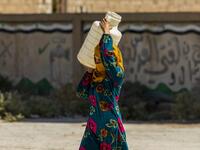 A displaced Syrian brings water back to their camp in a camp for the displaced in Syria's northeastern city of Hasakah on August 24, 2020. Delil SOULEIMAN / AFP