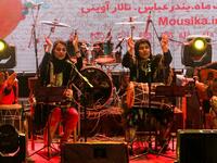 Members of the Iranian all-women music band "Dingo" (L to R) Malihe Shahinzadeh, Negin Heydari, Faezeh Mohseni, and Noushin Yousefzadeh perform together at a concert during the state-organised "Persian Gulf music" festival at Avini Hall in Iran's southern Gulf port city of Bandar Abbas on April 29, 2019. ATTA KENARE / AFP
