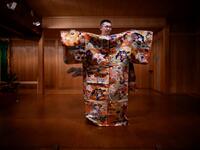 This photo taken on July 29, 2020 shows performer Kennosuke Nakamori posing for a photo with a costume after an interview with AFP at the Kamakura Noh Theatre in the town of Kamakura in Kanagawa Prefecture, about one hour southwest of Tokyo. Philip FONG / AFP
