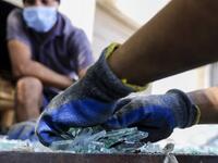 Workers sort through broken glass at factory, which is recycling the broken glass as a result of the Beirut explosion, in the northern Lebanese port city of Tripoli on August 25, 2020. The August 4 port explosion ripped through countless glass doors and windows when it laid waste to whole Beirut neighbourhoods, killing at least 190 people and wounding thousands more. Volunteers, non-governmental groups and entrepreneurs salvaged a fraction of the tonnes of broken glass that littered the streets, some of it 