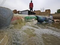 A Sudanese man stands behind a barricade amidst flood waters in Tuti island, where the Blue and White Nile merge between the twin cities of the capital Khartoum and Omdurman, on September 3, 2020. ASHRAF SHAZLY / AFP