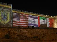 The flags of US, Israel, United Arab Emirates, and Bahrain are projected on the ramparts of Jerusalem's Old City on September 15, 2020 in a show of support for Israeli normalisation deals with the United Arab Emirates and Bahrain. The decision by the UAE and Bahrain to normalise ties with Israel breaks with decades of consensus within the Arab world that a peace deal with the Palestinians is a prerequisite for establishing relations with the Jewish state. Menahem Kahana / AFP