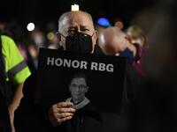 People pay their respects to Ruth Bader Ginsburg near the US Supreme Court in Washington, DC on September 19, 2020. US President Donald Trump vowed to quickly nominate a successor, likely a woman, to replace late Supreme Court Justice Ruth Bader Ginsburg, only a day after the death of the liberal stalwart. Eric BARADAT / AFP