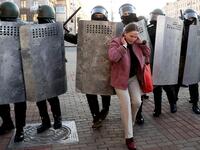 A woman hustles with law enforcement officers as they block the road during a demonstration called by opposition movement for an end to the regime of authoritarian leader in Minsk on September 20, 2020. Belarus President Alexander Lukashenko, who has ruled the ex-Soviet state for 26 years, claimed to have defeated opposition leader Svetlana Tikhanovskaya with 80 percent of the vote in the August 9, elections. AFP