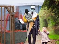 A Doctors Without Borders (MSF), health worker in protective clothing carries a child suspected of having Ebola in the MSF treatment center on October 5, 2014 in Paynesville, Liberia. The girl and her mother, showing symptoms of the deadly disease, were awaiting test results for the virus. The Ebola epidemic has killed more than 3,400 people in West Africa, according to the World Health Organization.  (ugurgallen/ Instagram)