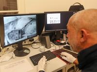 Gaby Maamary, a Lebanese artwork conservation specialist, checks an image scan during an interview at his studio in the capital Beirut on September 17, 2020. The blast at the capital's port on August 4 killed more than 190 people, and wounded thousands more as it sent lethal shockwaves pummelling through the city. But it also ravaged dozens of the capital's mot cherished heritage buildings. ANWAR AMRO / AFP