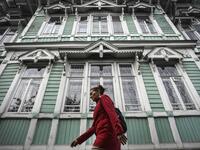 A woman walks past former house of Russian architect Stanislav Khomich, 1904, a traditional wooden house in the Siberian city of Tomsk, on September 8, 2020. Tomsk is considered to be one of the oldest towns in Siberia founded in 1604. Wooden architecture is one of the symbols of the city of Tomsk, its distinctive feature. Today Tomsk is the only city in Siberia where the background wooden buildings have been preserved, reflecting the manor structure of the city streets. Unfortunately, many wooden houses ar