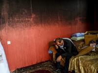 Razim Mehmedov, 40, sits in a bedroom of his flat that was damaged and burnt by shelling as residents return to their homes following a ceasefire during a military conflict between Armenia and Azerbaijan over the breakaway region of Nagorno-Karabakh, in the town of Terter, Azerbaijan, on October 10, 2020. Armenia and Azerbaijan traded accusations of new attacks on October 10 in breach of a ceasefire deal to end nearly two weeks of heavy fighting over the disputed Nagorno-Karabakh region. Bulent Kilic / AFP