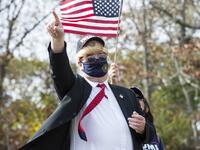 People dressed in political costumes participate in a contest during a Trump campaign rally named "Trumptoberfest" at Rocky Point Park in Warwick, Rhode Island on October 11, 2020. Many supporters dressed in political campaign clothing and waved flags while others dressed in festive costumes to take part in a political costume contest. Joseph Prezioso / AFP