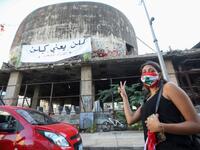 A Lebanese protester flashes the victory sign during a demonstration marking the one year anniversary of the beginning of a nationwide anti-government protest movement, in the capital Beirut on October 17, 2020. ANWAR AMRO / AFP