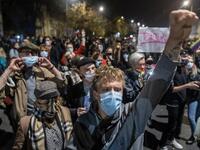 Protestors shout slogans as they are blocked by riot police guarding the house of Jaroslaw Kaczynski, leader of Poland's ruling Law and Justice party (PIS) during a demonstration against a decision by the Constitutional Court on abortion law restriction,in Warsaw on October 23, 2020. Wojtek RADWANSKI / AFP