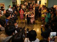 This photograph taken on October 22, 2020 shows 89-year-old Vietnamese artist Mong Bich addressing guests during the opening of her first solo exhibition at the French Cultural Centre in Hanoi. Bich specialises in silk paintings of daily life and ordinary people, women in particular, and ploughed a lonely furrow during many years of war when artists were steered towards the army or frontline workers as subjects. Manan VATSYAYANA / AFP