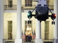 U.S. President Donald Trump stands on the Blue Room Balcony as Marine One takes off from the South Lawn of the White House on October 5, 2020 in Washington, DC. Trump was treated for Covid-19 at Walter Reed National Military Medical Center. Drew Angerer/Getty Images/AFP Drew Angerer / GETTY IMAGES NORTH AMERICA / Getty Images via AFP