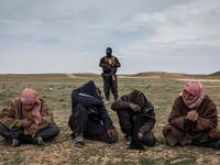 Men who have fled a final area of IS control wait to be questioned near Baghuz, Syria, about their links to the group, on 7 February 2019.⁣ ⁣ From ‘ISIS and its Aftermath in Syria’ by Ivor Prickett (@ivorprickett) for The New York Times (@nytimes).⁣