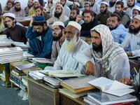 In this picture taken on October 19, 2020 Islamic seminary students gather in the premises of the hostel at the Darul Uloom Haqqania seminary in Akora Khattak which has churned out a who's who of Taliban top brass -- including many now on the hardline group's negotiating team holding talks with the Kabul government to end a 20-year war. Abdul MAJEED / AFP