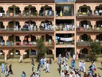 In this picture taken on October 19, 2020 Islamic seminary students gather in the premises of the hostel at the Darul Uloom Haqqania seminary in Akora Khattak which has churned out a who's who of Taliban top brass -- including many now on the hardline group's negotiating team holding talks with the Kabul government to end a 20-year war. Abdul MAJEED / AFP