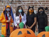 People pose for a photo booth picture at the "Halloween Driving Howl" event in Alhambra, California, on October 31, 2020. The city of Alhambra is holding several social distancing Halloween events as the Covid-19 pandemic continues to worsen across much of the nation. DAVID MCNEW / AFP